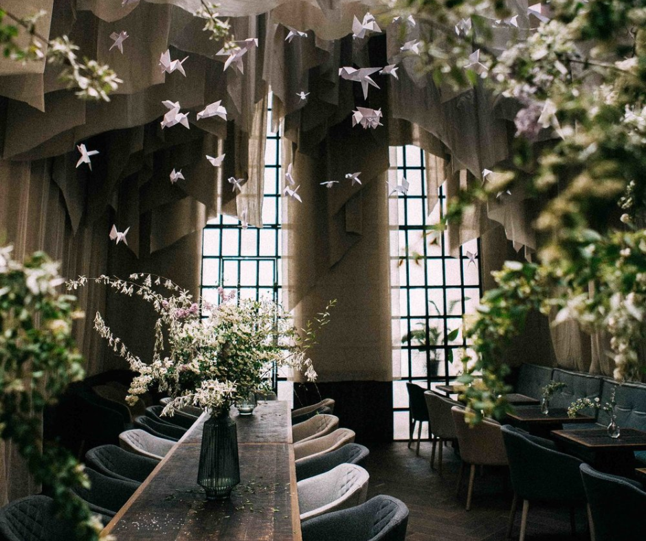 a beautiful modern restaurant with flower arrangements.